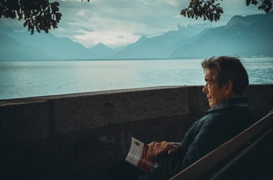 Old man watching sunset in mountains